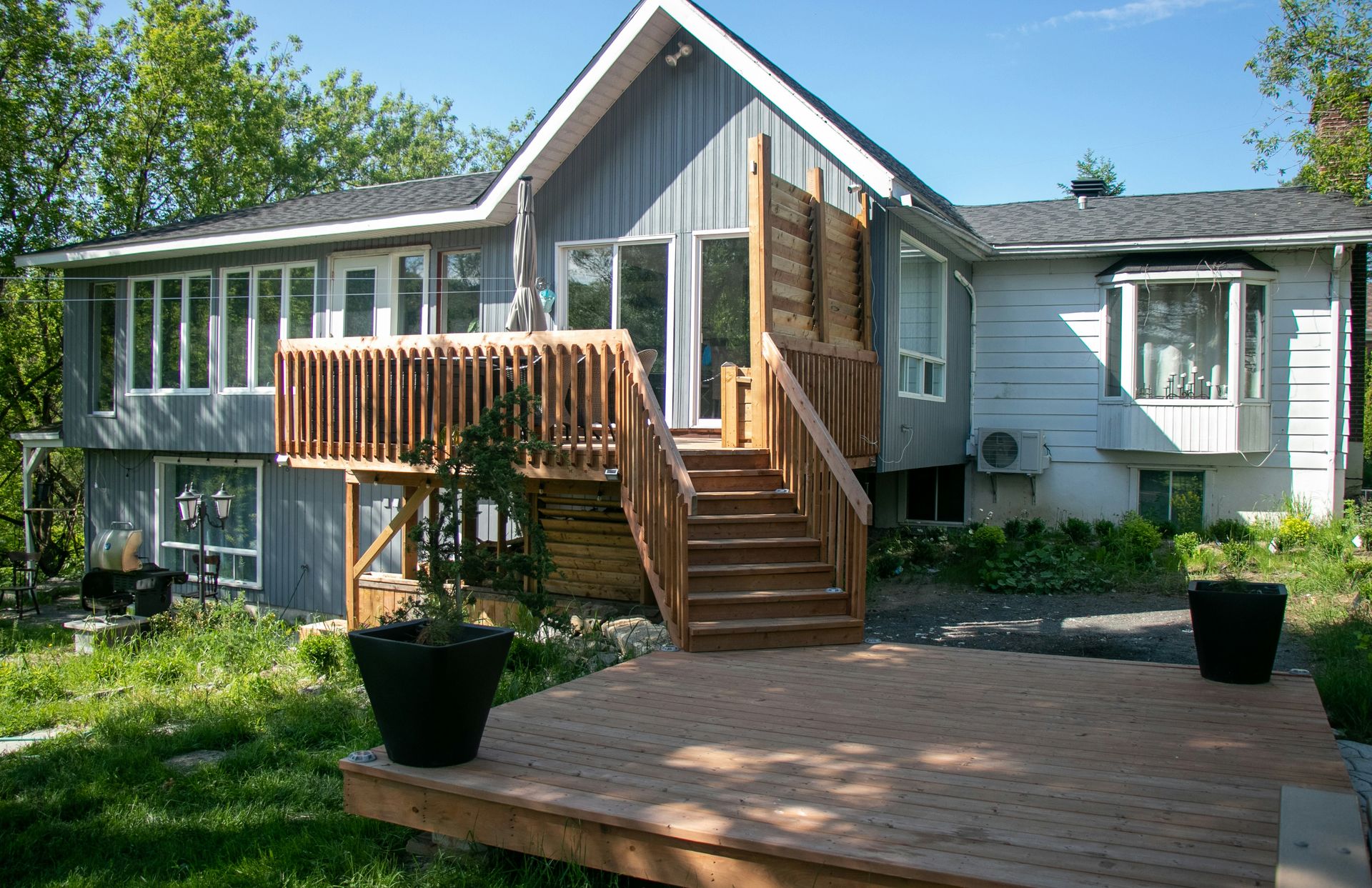 a house with a deck and stairs leading up to it